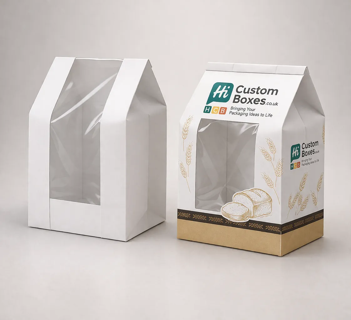 Two white gable-style bread boxes with large clear windows, one printed with wheat motifs and branding. class=
